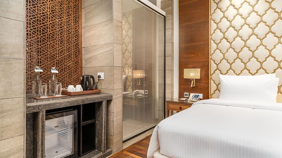 An image of our deluxe room with a minibar, a double bed, and a shower cubicle - Sarovar Premiere, Srinagar 